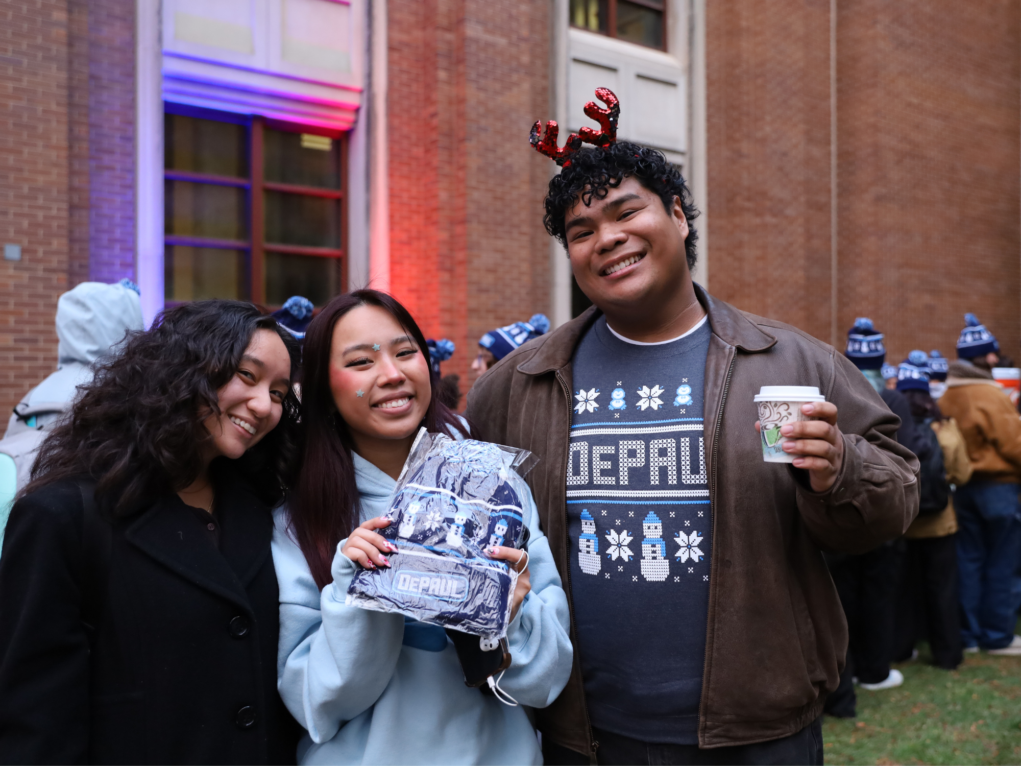 Students pose with a DePaul hat